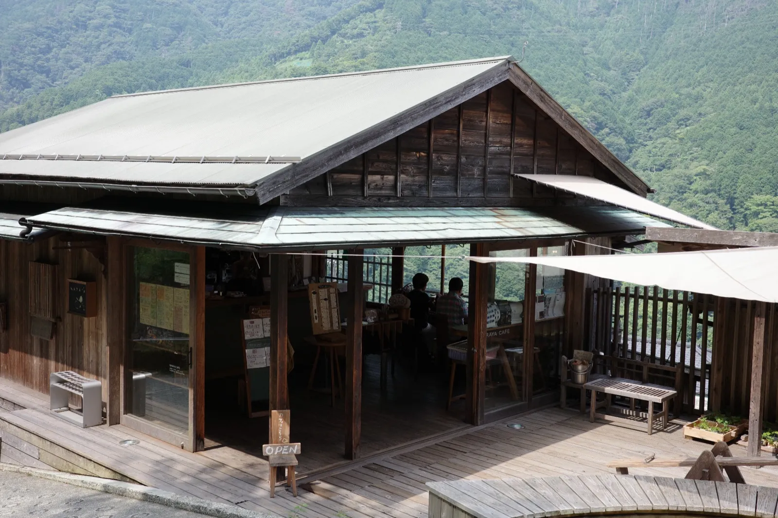 NARAYA CAFEの外観。山を望む木造の建物とテラス席